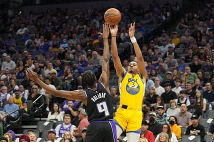 Apr 3, 2022; Sacramento, California, USA; Golden State Warriors guard Jordan Poole (3) shoots against Sacramento Kings forward Justin Holiday (9) during the first quarter at Golden 1 Center. Mandatory Credit: Darren Yamashita-USA TODAY Sports