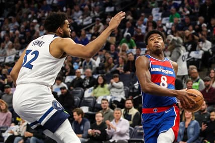 Apr 5, 2022; Minneapolis, Minnesota, USA; Washington Wizards forward Rui Hachimura (8) drives to the basket while Minnesota Timberwolves center Karl-Anthony Towns (32) defends in the first quarter at Target Center. Mandatory Credit: David Berding-USA TODAY Sports