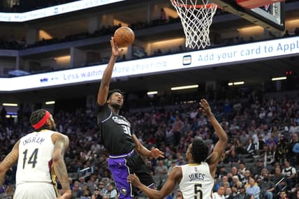 Apr 5, 2022; Sacramento, California, USA; Sacramento Kings center Damian Jones (30) shoots against New Orleans Pelicans forward Herbert Jones (5) during the second quarter at Golden 1 Center. Mandatory Credit: Darren Yamashita-USA TODAY Sports