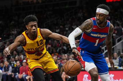 Apr 6, 2022; Atlanta, Georgia, USA; Washington Wizards guard Kentavious Caldwell-Pope (1) tries to make a play against Atlanta Hawks forward De'Andre Hunter (12) during the first half at State Farm Arena. Mandatory Credit: Dale Zanine-USA TODAY Sports
