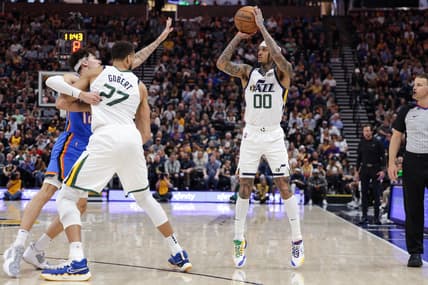 Apr 6, 2022; Salt Lake City, Utah, USA;  Utah Jazz guard Jordan Clarkson (00) shoots the ball while Utah Jazz center Rudy Gobert (27) keeps Oklahoma City Thunder forward Lindy Waters III (12) from attempting to block the shot during the second half at Vivint Arena. Utah Jazz won 137-101. Mandatory Credit: Chris Nicoll-USA TODAY Sports