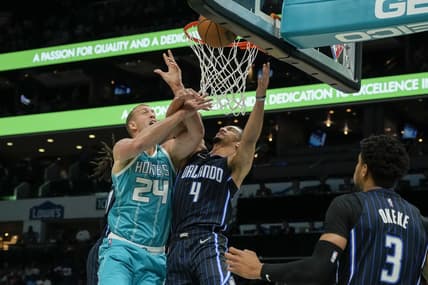 Apr 7, 2022; Charlotte, North Carolina, USA; Charlotte Hornets center Mason Plumlee (24) gets fouled on his shot attempt by Orlando Magic guard Jalen Suggs (4) during the first quarter at Spectrum Center. Mandatory Credit: Jim Dedmon-USA TODAY Sports