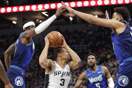 Apr 7, 2022; Minneapolis, Minnesota, USA; San Antonio Spurs forward Keldon Johnson (3) controls the ball as Minnesota Timberwolves forward Jarred Vanderbilt (8) and center Karl-Anthony Towns (32) defend in the first quarter at Target Center. Mandatory Credit: Bruce Kluckhohn-USA TODAY Sports