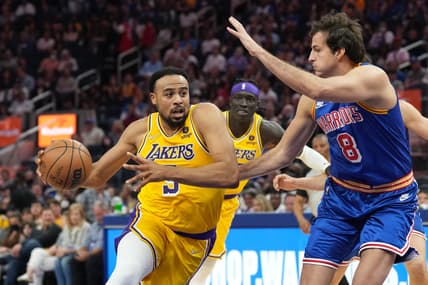 Apr 7, 2022; San Francisco, California, USA; Los Angeles Lakers guard Talen Horton-Tucker (5) dribbles against Golden State Warriors forward Nemanja Bjelica (8) during the second quarter at Chase Center. Mandatory Credit: Darren Yamashita-USA TODAY Sports