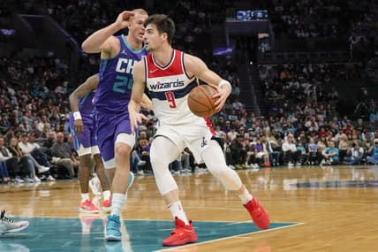 Apr 10, 2022; Charlotte, North Carolina, USA;Washington Wizards forward Deni Avdija (9) drives to the basket against Charlotte Hornets center Mason Plumlee (24) during the first quarter at Spectrum Center. Mandatory Credit: Jim Dedmon-USA TODAY Sports