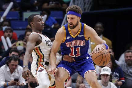 Apr 10, 2022; New Orleans, Louisiana, USA;  Golden State Warriors guard Klay Thompson (11) dribbles against New Orleans Pelicans guard Jared Harper (2) during the second half at the Smoothie King Center. Mandatory Credit: Stephen Lew-USA TODAY Sports