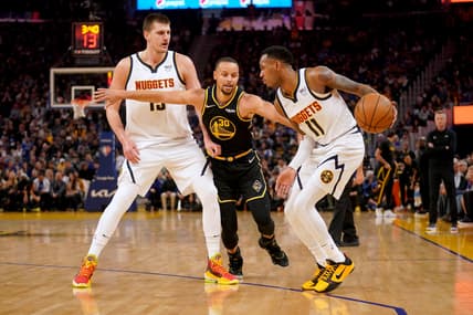 Apr 16, 2022; San Francisco, California, USA; Golden State Warriors guard Stephen Curry (30) reaches past Denver Nuggets center Nikola Jokic (15) to pressure guard Monte Morris (11) in the first quarter during game one of the first round for the 2022 NBA playoffs at the Chase Center. Mandatory Credit: Cary Edmondson-USA TODAY Sports