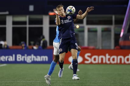Apr 16, 2022; Foxborough, Massachusetts, USA; New England Revolution forward Adam Buksa (9) tries to control the ball in front of Charlotte FC defender Christian Makoun (14) during the second half at Gillette Stadium. Mandatory Credit: Winslow Townson-USA TODAY Sports