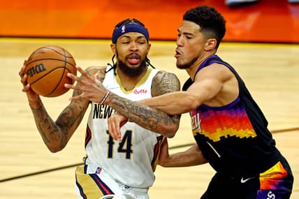 Apr 19, 2022; Phoenix, Arizona, USA; New Orleans Pelicans forward Brandon Ingram (14) drives to the basket against Phoenix Suns guard Devin Booker (1) during the first quarter during game two of the first round for the 2022 NBA playoffs at Footprint Center. Mandatory Credit: Mark J. Rebilas-USA TODAY Sports