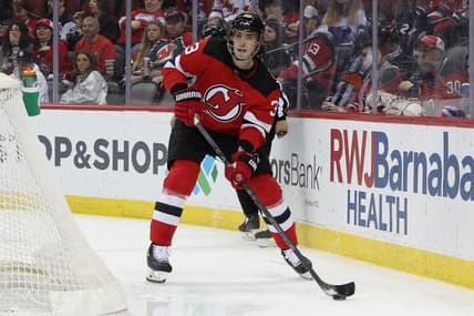 Apr 23, 2022; Newark, New Jersey, USA; New Jersey Devils defenseman Ryan Graves (33) controls the puck against the Carolina Hurricanes during the first period at Prudential Center. Mandatory Credit: Vincent Carchietta-USA TODAY Sports