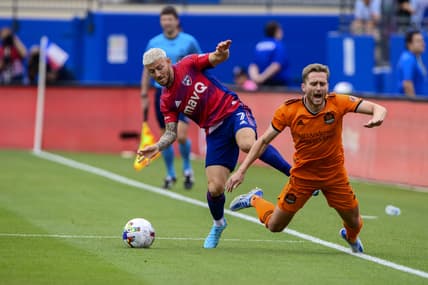 Apr 23, 2022; Frisco, Texas, USA; FC Dallas forward Paul Arriola (7) and Houston Dynamo defender Adam Lundqvist (3) fight for the ball during the first half at Toyota Stadium. Mandatory Credit: Jerome Miron-USA TODAY Sports