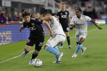 Apr 23, 2022; Washington, District of Columbia, USA;  D.C. United midfielder Theodore Ku-DiPietro (35) dribbles the ball as New England Revolution midfielder Damian Rivera (72) defends in the second half at Audi Field. Mandatory Credit: Geoff Burke-USA TODAY Sports
