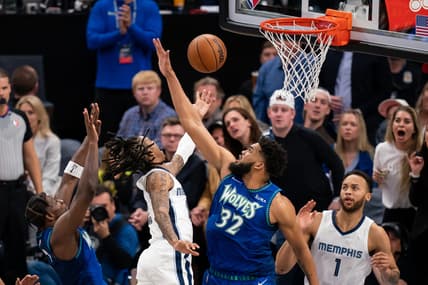 Apr 29, 2022; Minneapolis, Minnesota, USA; Memphis Grizzlies guard Ja Morant (12) shoots against the Minnesota Timberwolves center Karl-Anthony Towns (32) in the second quarter during game six of the first round for the 2022 NBA playoffs at Target Center. Mandatory Credit: Brad Rempel-USA TODAY Sports