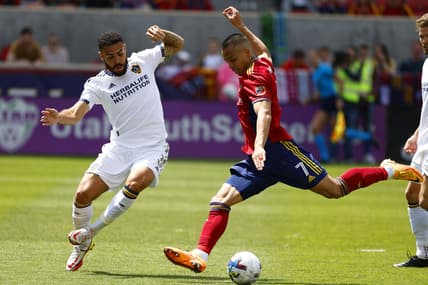 Apr 30, 2022; Sandy, Utah, USA;  Los Angeles Galaxy defender Derrick Williams (3) and Real Salt Lake forward Bobby Wood (7) battle in the first half at Rio Tinto Stadium. Mandatory Credit: Jeffrey Swinger-USA TODAY Sports