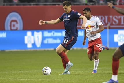 Apr 30, 2022; Chicago, Illinois, USA;  Chicago Fire midfielder Gast  n Gim  nez (30) moves the ball against New York Red Bulls midfielder Cristian C  sseres Jr (23) during the first half at Soldier Field. Mandatory Credit: Matt Marton-USA TODAY Sports