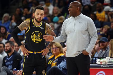 Mar 28, 2022; Memphis, Tennessee, USA; Golden State Warriors assistant coach Mike Brown (right) talks with guard Chris Chiozza (2) during the second half at FedExForum. Brown took over head coaching duties after head coach Steve Kerr (not pictured) was ejected from the game. Mandatory Credit: Petre Thomas-USA TODAY Sports