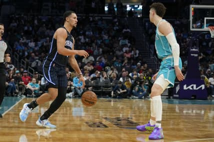 Apr 7, 2022; Charlotte, North Carolina, USA; Orlando Magic guard Jalen Suggs (4) dribbles the ball while defended by Charlotte Hornets guard LaMelo Ball (2) during the second half at Spectrum Center. Mandatory Credit: Jim Dedmon-USA TODAY Sports