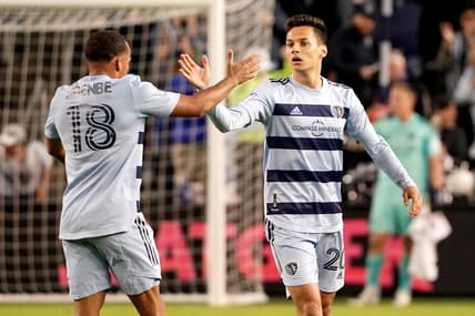 Apr 30, 2022; Kansas City, Kansas, USA; Sporting Kansas City forward Daniel Salloi (20) celebrates with defender Logan Ndenbe (18) after scoring against FC Dallas during the second half at Children's Mercy Park. Mandatory Credit: Denny Medley-USA TODAY Sports