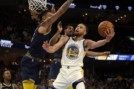 May 3, 2022; Memphis, Tennessee, USA; Golden State Warriors guard Stephen Curry (30) drives to the basket as Memphis Grizzlies forward Brandon Clarke (15) defends during the second half in game two of the second round for the 2022 NBA playoffs at FedExForum. Mandatory Credit: Petre Thomas-USA TODAY Sports