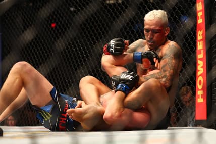 May 7, 2022; Phoenix, Arizona, USA; Charles Oliveira applies a hold against Justin Gaethje during UFC 274 at Footprint Center. Mandatory Credit: Mark J. Rebilas-USA TODAY Sports