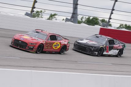 May 8, 2022; Darlington, South Carolina, USA; NASCAR Cup Series driver Joey Logano (22) races NASCAR Cup Series driver Ross Chastain (1) during the Goodyear 400 at Darlington Raceway. Mandatory Credit: Jasen Vinlove-USA TODAY Sports