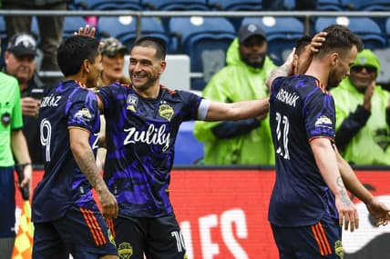 May 15, 2022; Seattle, Washington, USA; Seattle Sounders FC midfielder Nicolas Lodeiro (10) celebrates with forward Raul Ruidiaz (9)) after scoring a goal against the Minnesota United FC during the second half at Lumen Field. Mandatory Credit: Joe Nicholson-USA TODAY Sports