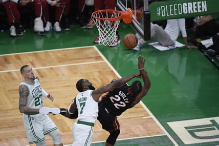May 21, 2022; Boston, Massachusetts, USA; Boston Celtics guard Jaylen Brown (7) fouls Miami Heat forward Jimmy Butler (22) in the first half during game three of the 2022 eastern conference finals at TD Garden. Mandatory Credit: Bob DeChiara-USA TODAY Sports