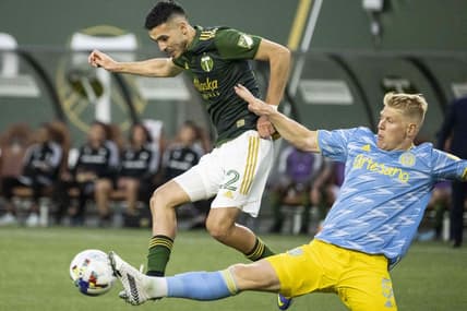 May 22, 2022; Portland, Oregon, USA; Philadelphia Union defender Jakob Glesnes (5) defends Portland Timbers midfielder Cristhian Paredes (22) during the first half at Providence Park. Mandatory Credit: Troy Wayrynen-USA TODAY Sports