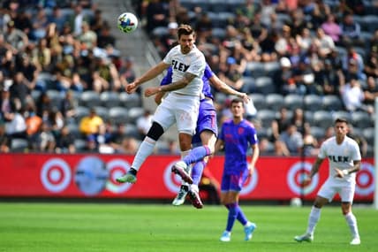 May 28, 2022; Los Angeles, California, USA; Los Angeles FC midfielder Ryan Hollingshead (24) plays for the ball against San Jose Earthquakes midfielder Jan Gregus (17)  during the first half at Banc of California Stadium. Mandatory Credit: Gary A. Vasquez-USA TODAY Sports