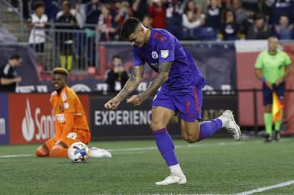 May 28, 2022; Foxborough, Massachusetts, USA; New England Revolution forward Gustavo Bou (7) celebrates his penalty goal against Philadelphia Union goalkeeper Andre Blake (18) during the second half at Gillette Stadium. Mandatory Credit: Winslow Townson-USA TODAY Sports