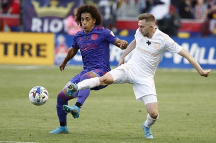 May 28, 2022; Sandy, Utah, USA; Houston Dynamo midfielder Adalberto Carrasquilla (20) and Real Salt Lake defender Andrew Brody (2) battle in the first half at Rio Tinto Stadium. Mandatory Credit: Jeffrey Swinger-USA TODAY Sports