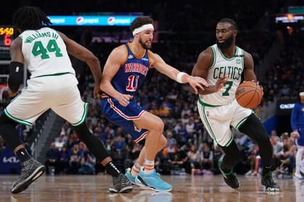 Mar 16, 2022; San Francisco, California, USA; Boston Celtics guard Jaylen Brown (7) dribbles the ball next to Golden State Warriors guard Klay Thompson (11) in the third quarter at the Chase Center. Mandatory Credit: Cary Edmondson-USA TODAY Sports
