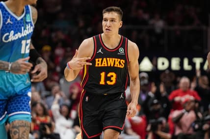 Apr 13, 2022; Atlanta, Georgia, USA; Atlanta Hawks guard Bogdan Bogdanovic (13) reacts after making a three point shot against the Charlotte Hornets during the first half at State Farm Arena. Mandatory Credit: Dale Zanine-USA TODAY Sports