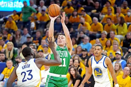 Jun 5, 2022; San Francisco, California, USA; Boston Celtics guard Payton Pritchard (11) shoots the ball against Golden State Warriors forward Draymond Green (23) during game two of the 2022 NBA Finals at Chase Center. Mandatory Credit: Kyle Terada-USA TODAY Sports