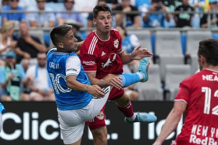 Jun 11, 2022; Charlotte, North Carolina, USA; New York Red Bulls defender Sean Nealis (15) after a header against Charlotte FC forward Cristian Ortiz (10) during first half action at Bank of America Stadium. Mandatory Credit: Jim Dedmon-USA TODAY Sports