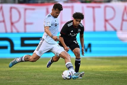 Jun 18, 2022; Chicago, Illinois, USA;  Chicago Fire FC midfielder Gaston Gimenez (30) controls the ball against DC United midfielder Sofiane Djeffal (13) in the first half at Soldier Field. Mandatory Credit: Jamie Sabau-USA TODAY Sports