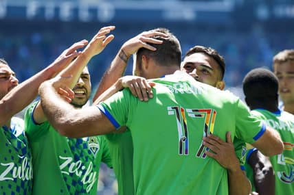 Jun 25, 2022; Seattle, Washington, USA; Seattle Sounders FC defender Will Bruin (17) celebrates with midfielder Nicolas Lodeiro (10, left), midfielder Alex Roldan (16, second from left) and midfielder Cristian Roldan (7, right) after scoring a goal against Sporting Kansas City during the first half at Lumen Field. Mandatory Credit: Joe Nicholson-USA TODAY Sports