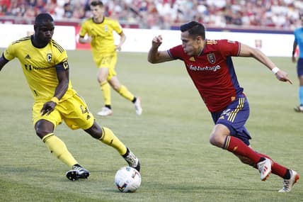 Jun 25, 2022; Sandy, Utah, USA; Real Salt Lake forward Rubio Rubin (14) looks to gets past Columbus Crew defender Jonathan Mensah (4) in the first half at Rio Tinto Stadium. Mandatory Credit: Jeffrey Swinger-USA TODAY Sports