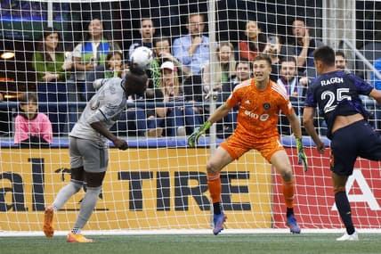Jun 29, 2022; Seattle, Washington, USA; CF Montreal forward Kei Kamara (23) heads away the ball against the Seattle Sounders FC during the first half at Lumen Field. CF Montreal goalkeeper Sebastian Breza (1) watches the play. Mandatory Credit: Joe Nicholson-USA TODAY Sports