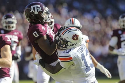 Nov 6, 2021; College Station, Texas, USA; Texas A&M Aggies wide receiver Ainias Smith (0) calls for a fair catch then is tackled by Auburn Tigers safety Ladarius Tennison (13) in the second quarter at Kyle Field. The Tigers were called for a penalty on the play. Mandatory Credit: Thomas Shea-USA TODAY Sports