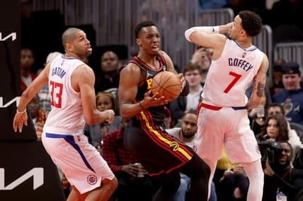 Mar 11, 2022; Atlanta, Georgia, USA; Atlanta Hawks forward Onyeka Okongwu (17) grabs a rebound against LA Clippers forward Nicolas Batum (33) and guard Amir Coffey (7) during the second half at State Farm Arena. Mandatory Credit: Jason Getz-USA TODAY Sports