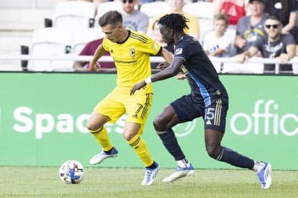 Jul 3, 2022; Columbus, Ohio, USA; Columbus Crew forward Pedro Santos (7) advances past Philadelphia Union defender Olivier Mbaizo (15) in the first half at Lower.com Field. Mandatory Credit: Greg Bartram-USA TODAY Sports