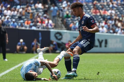 Jul 9, 2022; New York, New York, USA; New York City FC midfielder Santiago Rodriguez (20) collides with New England Revolution midfielder Brandon Bye (15) during the first half at Yankee Stadium. Mandatory Credit: Vincent Carchietta-USA TODAY Sports