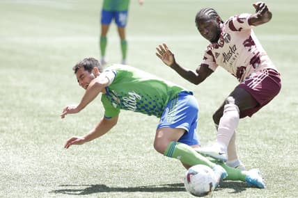 Jul 9, 2022; Seattle, Washington, USA; Seattle Sounders FC midfielder Nicolas Lodeiro (10) attempts to draw a foul against Portland Timbers forward Yimmi Chara (23) during the first half at Lumen Field. Mandatory Credit: Joe Nicholson-USA TODAY Sports