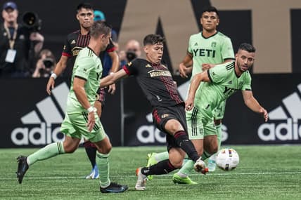 Jul 9, 2022; Atlanta, Georgia, USA; Atlanta United midfielder Matheus Rossetto (9) kicks the ball against Austin FC midfielder Felipe Martins (22) during the first half at Mercedes-Benz Stadium. Mandatory Credit: Dale Zanine-USA TODAY Sports