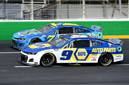 Jul 10, 2022; Hampton, Georgia, USA; NASCAR Cup Series driver Chase Elliott (9) and NASCAR Cup Series driver Corey LaJoie (7) race during the Quaker State 400 at Atlanta Motor Speedway. Mandatory Credit: Adam Hagy-USA TODAY Sports