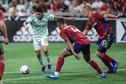 Jul 13, 2022; Atlanta, Georgia, USA; Atlanta United midfielder Thiago Almada (8) controls the ball past Real Salt Lake defender Johan Kappelhof (4) during the first half at Mercedes-Benz Stadium. Mandatory Credit: Dale Zanine-USA TODAY Sports