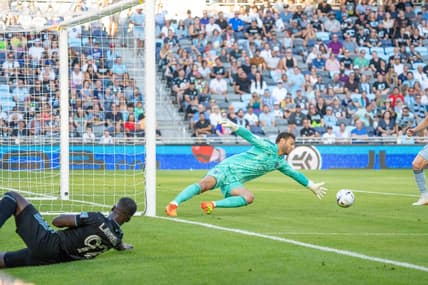Jul 13, 2022; Saint Paul, Minnesota, USA; Minnesota United defender Kemar Lawrence (92) looks on as Sporting Kansas City goalkeeper John Pulskamp (1) defends an own goal in the first half at Allianz Field. Mandatory Credit: Matt Blewett-USA TODAY Sports