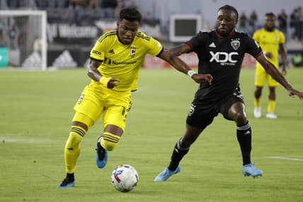 Jul 13, 2022; Washington, District of Columbia, USA; Columbus Crew midfielder Luis D az (12) dribbles the ball as D.C. United defender Chris Odoi-Atsem (3) defends in the first half at Audi Field. Mandatory Credit: Geoff Burke-USA TODAY Sports