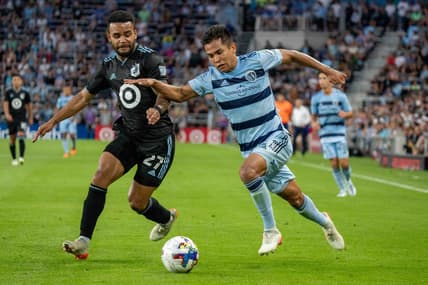 Jul 13, 2022; Saint Paul, Minnesota, USA; Sporting Kansas City midfielder Felipe Hernandez (21) is challenged by Minnesota United defender D.J. Taylor (27) in the second half at Allianz Field. Mandatory Credit: Matt Blewett-USA TODAY Sports